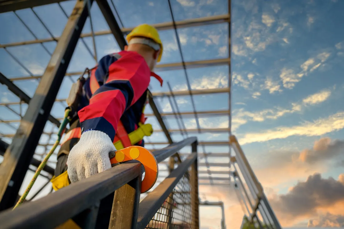 Construction worker wearing safety gear and harness